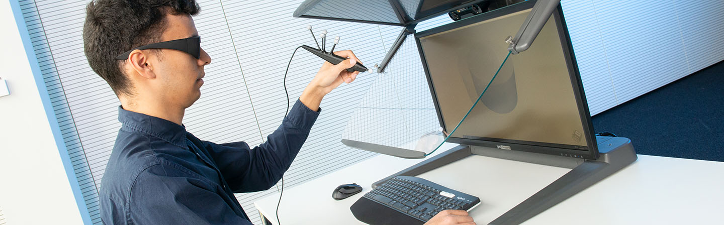 Engineer with stylus on a 3D monitor