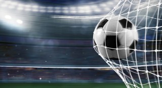 Ball scores a goal on the net in a football match